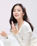 Woman holding a pink product against a white background
