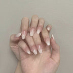 Close-up of a hand with neatly manicured nails against a neutral background