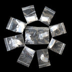 Silver foil packages with numbers on a black background