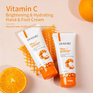 Two bottles of Dr. Rashel Vitamin C hand and foot cream with oranges on a light pink background