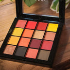 Makeup palette with colorful shades on a wooden surface