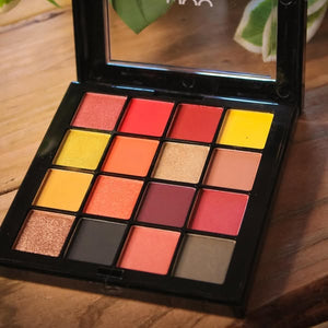 Makeup palette with colorful shades on a wooden surface