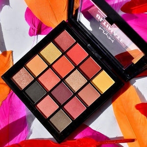 Makeup palette with colorful eyeshadows on a vibrant background