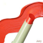 Close-up of a red lipstick with a beige casing on a white background