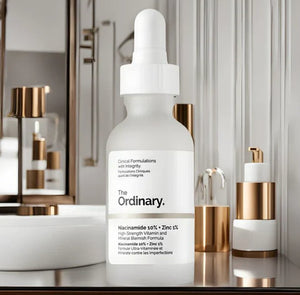 Skincare serum bottle labeled 'The Ordinary' on a bathroom counter with blurred background