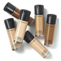 MAC foundation bottles in various shades on a white background