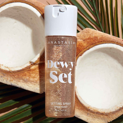 Anastasia Beverly Hills Dewy Set setting spray bottle with coconuts in the background