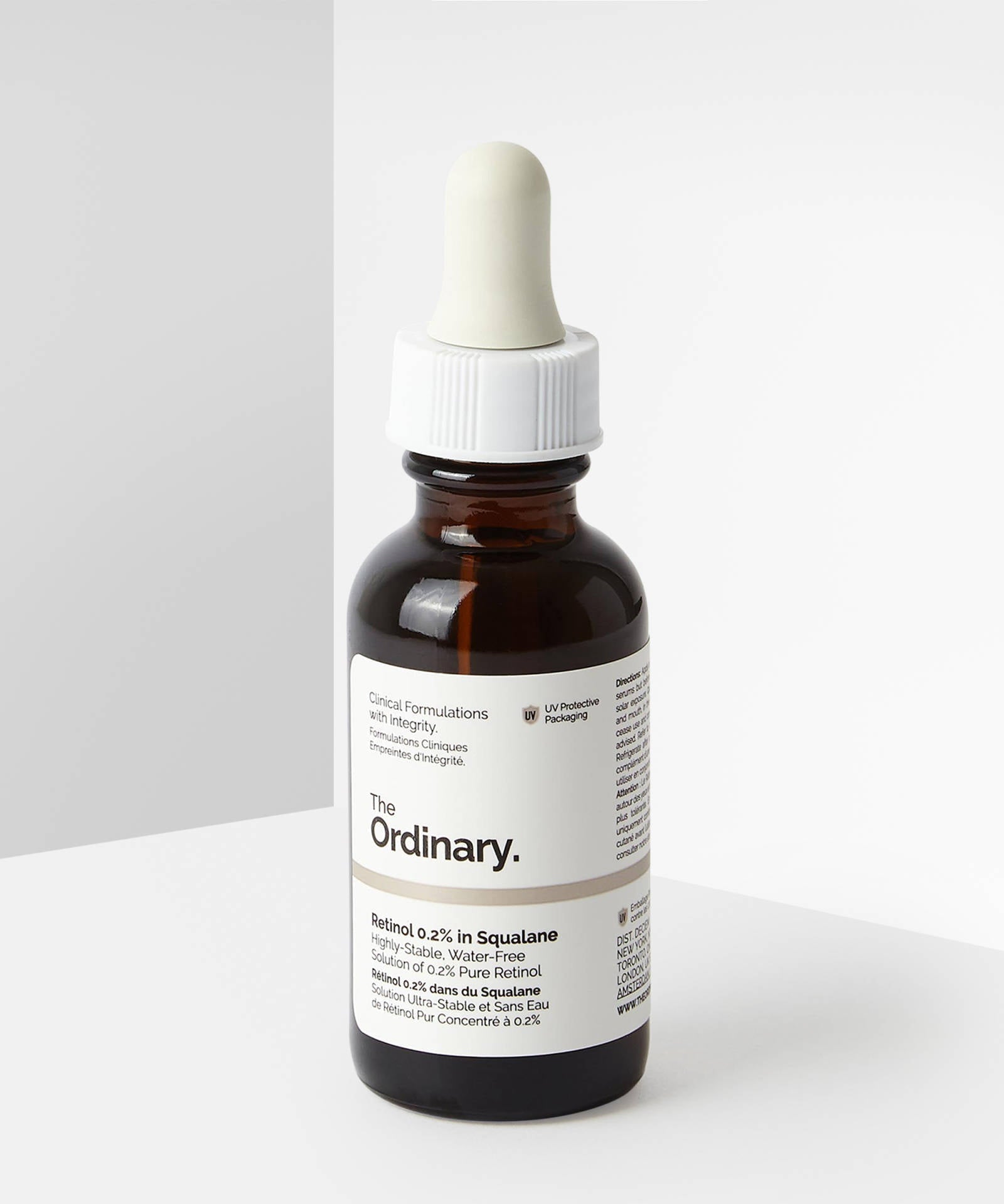 Bottle of 'The Ordinary' serum with dropper on a white background