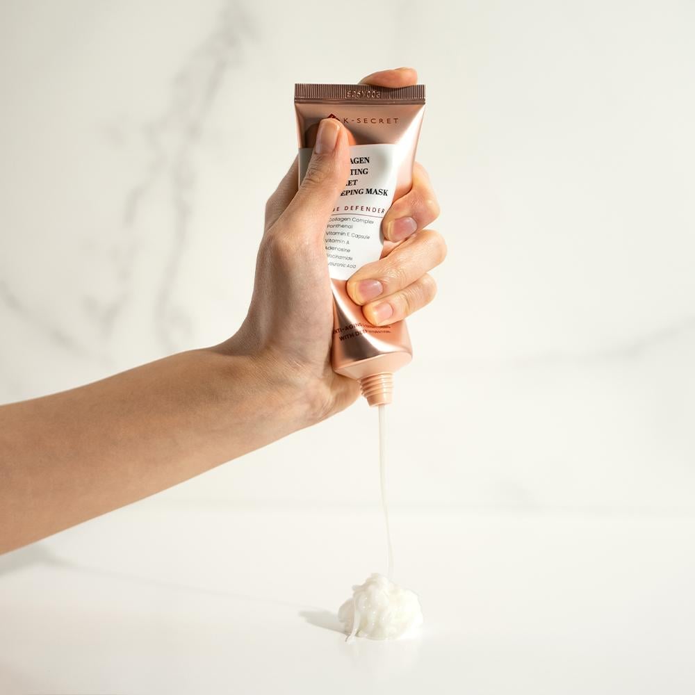 Hand holding a skincare product with a white background