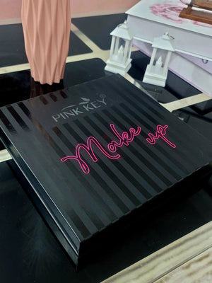 Black makeup palette with 'Make up' text on a reflective surface