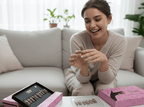 Woman sitting on a couch with makeup products in front of her