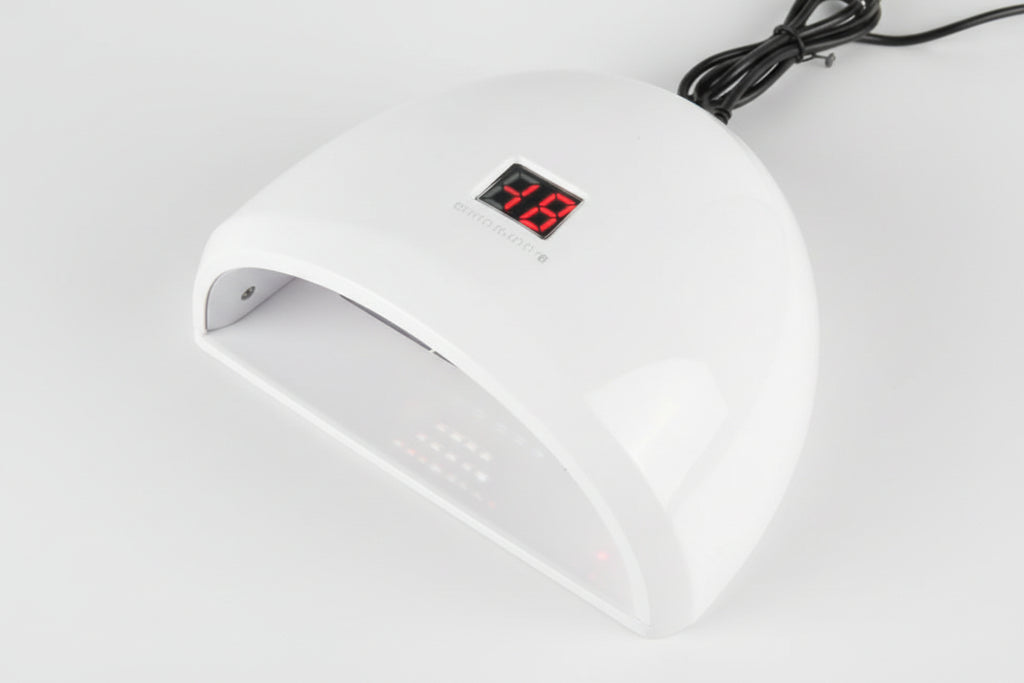 White electronic device with digital display on a light gray background