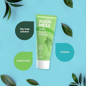 Green tube of Foot Ness foot scrub on a blue background with green leaves.