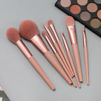 Set of makeup brushes with a makeup palette on a gray background
