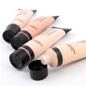 Four cosmetic foundation tubes on a white background