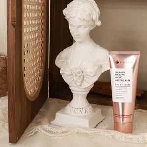 Collagen boosting serum sleeping mask next to a classical bust statue