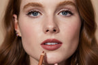 Close-up of a woman's face with a lip pencil