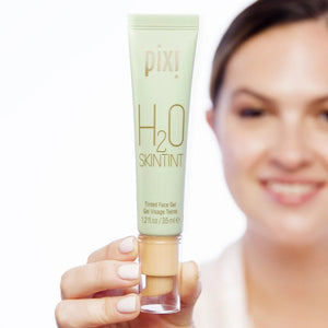 Pixi H2O Skintint product held by a person with a blurred background