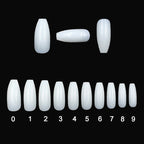 Set of white nail extensions on a black background with size measurement scale.
