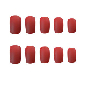 Red nail polish samples on a white background